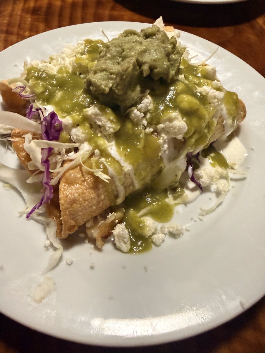 Enchiladas verdes with guacamole and cotija