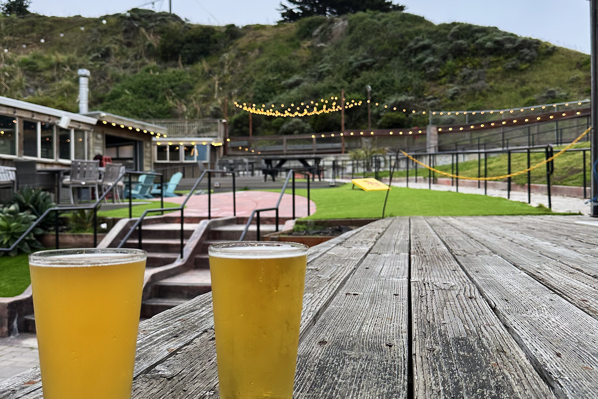 Two pints on a picnic table overlooking the beer garden