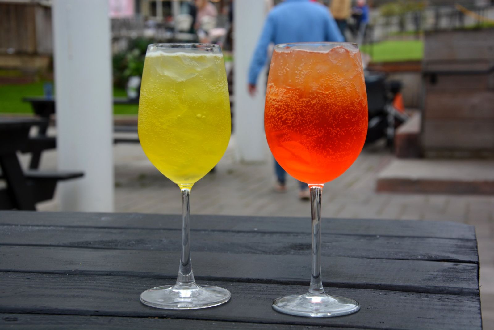 Two sparkling wine cocktails on a patio table